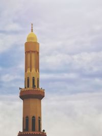 Low angle view of lighthouse against building