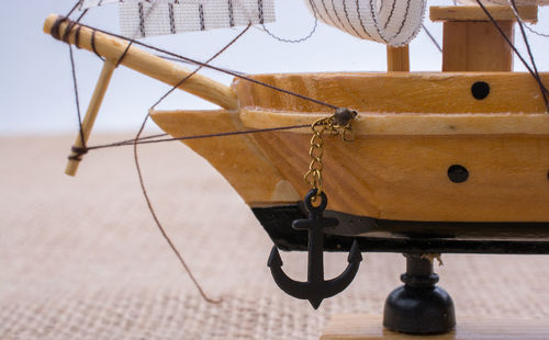 Close-up of chain hanging on rope against sea