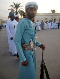 Portrait of friends standing on street in city