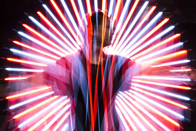 Blurred motion of person standing at night