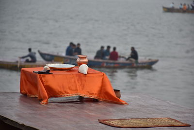 People sitting on table by boat