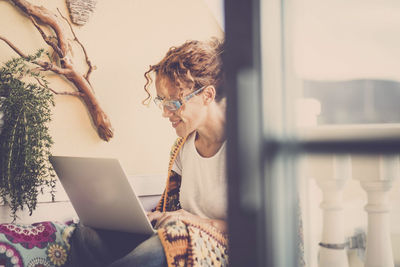 Woman using mobile phone at home