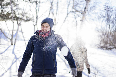 Friends attacking each other with snow balls