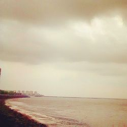 Scenic view of sea against cloudy sky