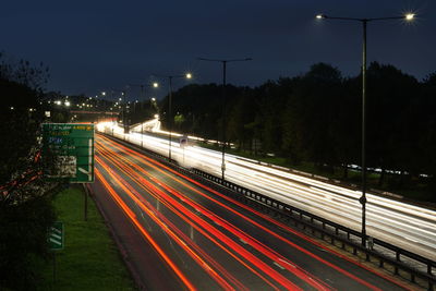 High angle view of light trails on road at night