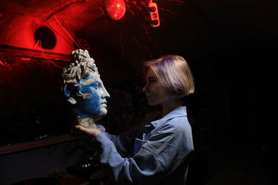 Woman touching sculpture on stage