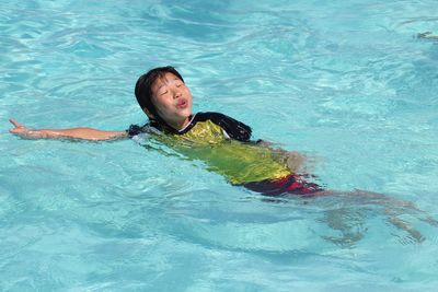 Teenage girl swimming in pool
