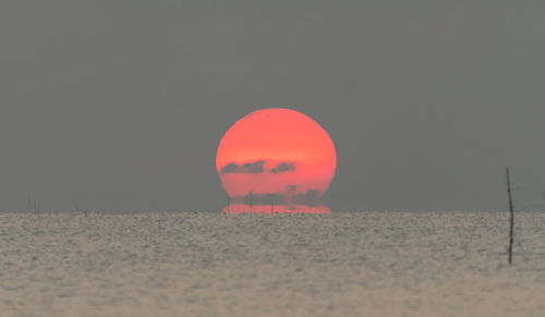 Surface level of beach against sky during sunset