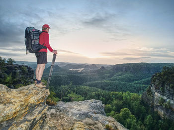 Amateur photographer. tourist photographer with big camera log and basalt tripod in hand on top 