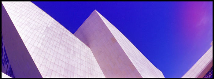 Low angle view of built structure against blue sky