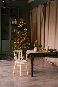 Wooden table and white chair in the christmas living room 