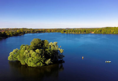 Scenic view of lake against clear blue sky