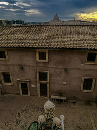 Houses against cloudy sky