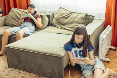 Young woman sitting on sofa at home