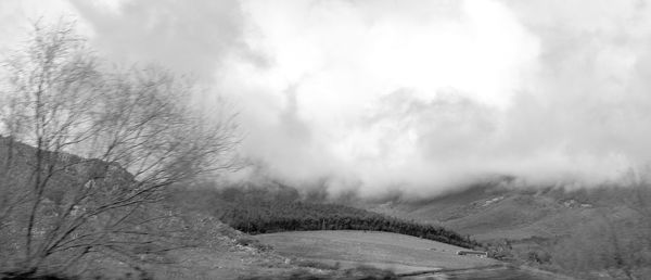 Scenic view of snow covered land against sky