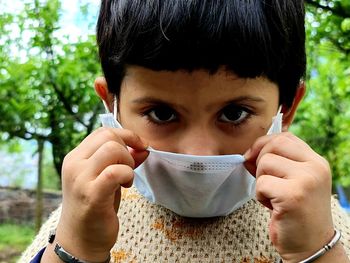 Portrait of girl wearing mask outdoors