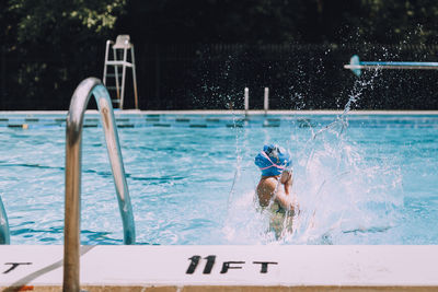 Girl playing in swimming pool