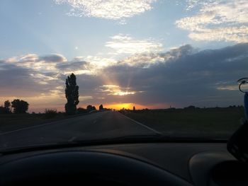 Car on road against sky during sunset