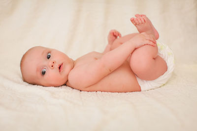 Cute baby lying on bed