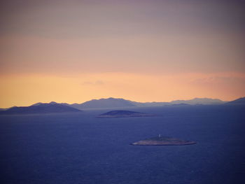 Scenic view of sea and mountains against sky