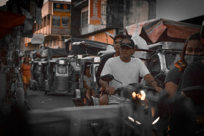 People looking at market stall in city