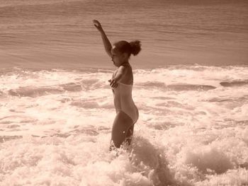 Woman jumping in sea