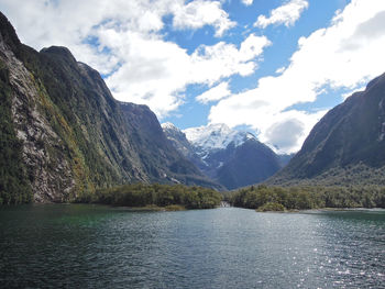 Scenic view of lake and mountains against sky