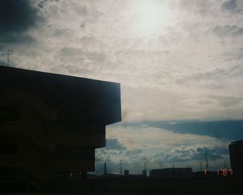 Low angle view of building against cloudy sky