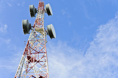 Low angle view of communications tower against blue sky