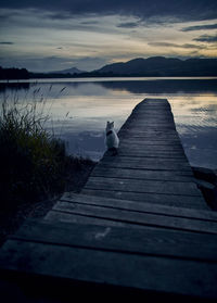 Pier over lake against sky