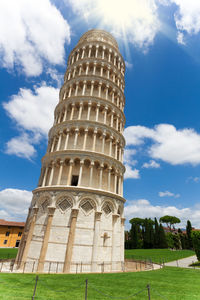 Low angle view of bell tower against cloudy sky