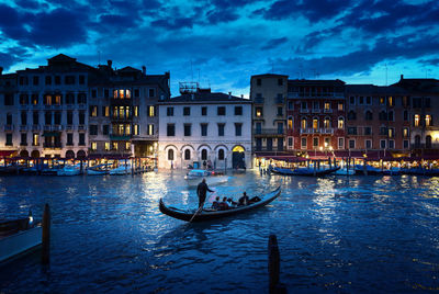 View of canal in city at dusk