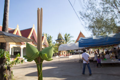 Group of people walking against built structures