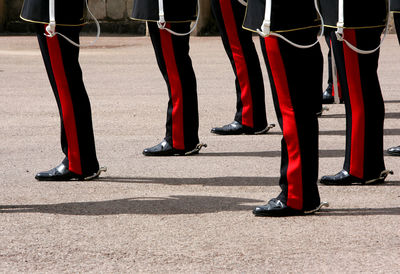 Low section of people standing on red floor