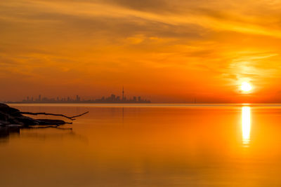 Scenic view of sea against orange sky