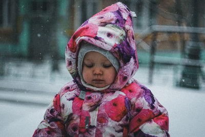 Close-up of cute girl standing in snow