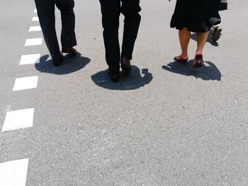 Low section of people standing on street