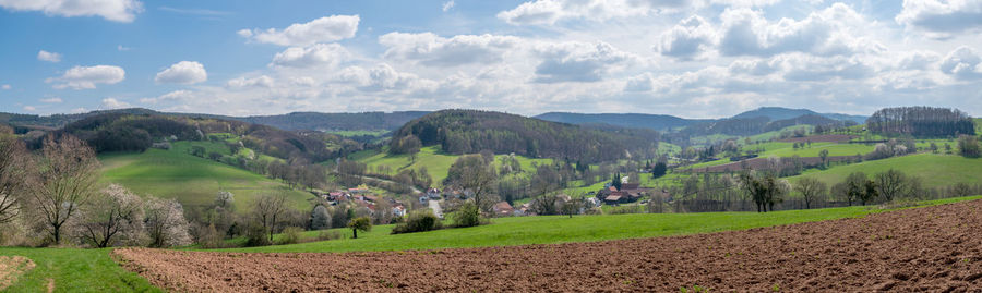 Panoramic view of agricultural field against sky