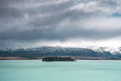 A scenic landscape of new zealand southern alps and lake tekapo with blue sky and clouds.