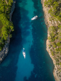 Aerial view of boats in beautiful sea bay, cala mitjana, mallorca, spain