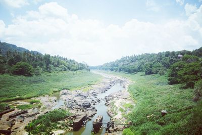 Scenic view of landscape against cloudy sky