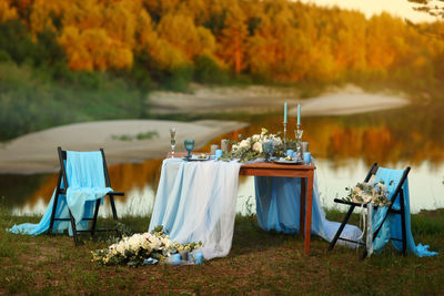 Festive table in blue tones on the banks of the river
