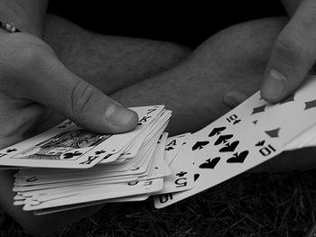 Close-up of cropped hand holding paper