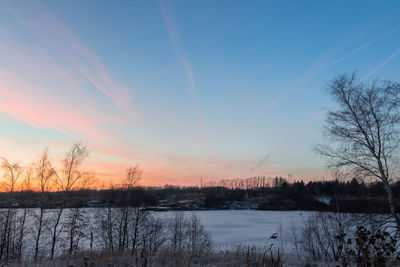 Scenic view of winter landscape against sky during sunset