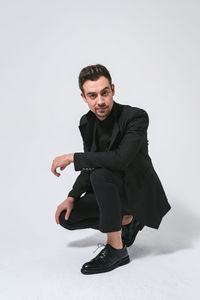 Portrait of young man against white background