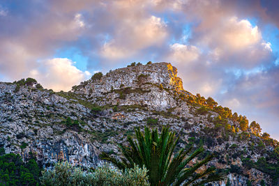 Low angle view of rock formation against sky during sunset