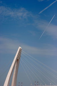 Low angle view of suspension bridge against sky