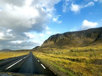 Road amidst landscape against sky