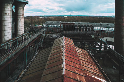 Tilt image of bridge against sky in city