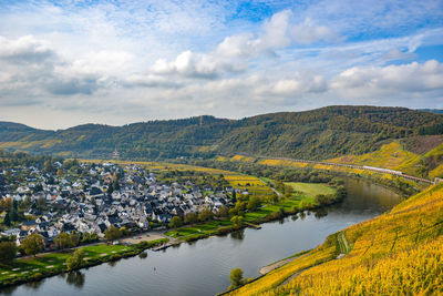 Scenic view of river and mountains against sky